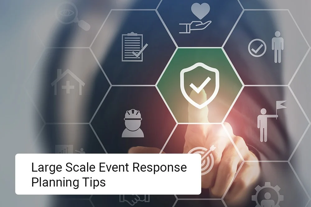Someone taps a digital shield checkmark icon on a hex-filled virtual screen, while Large Scale Event Emergency Response Planning Tips is displayed in a white box. Product Name: Blog image 3. Someone taps a digital shield checkmark icon on a hex-filled virtual screen, while Large Scale Event Emergency Response Planning Tips is displayed in a white box. Product Name: Blog image 3.