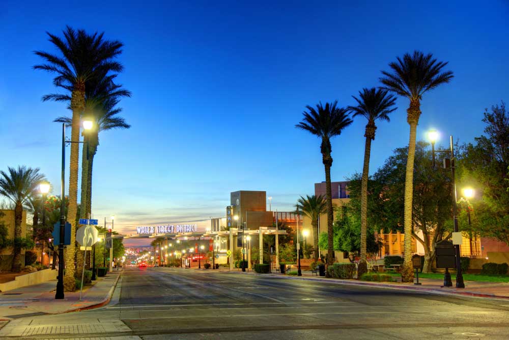 A quiet street lined with palm trees and streetlights at dusk in downtown Tempe, Arizona, showcases enhanced safety with Alexios-security-solutions-henderson-nevada, offering visitors a secure and welcoming atmosphere. A quiet street lined with palm trees and streetlights at dusk in downtown Tempe, Arizona, showcases enhanced safety with Alexios-security-solutions-henderson-nevada, offering visitors a secure and welcoming atmosphere.