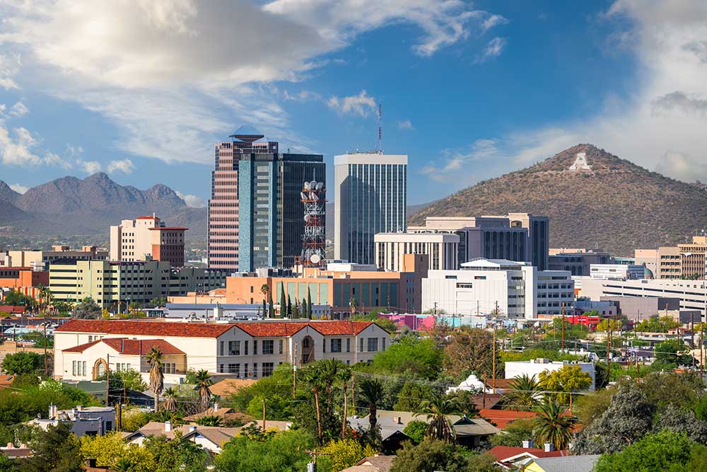 Downtown Tucson, Arizona cityscape features tall buildings, palm trees, mountains, and the large letter A on a hillside under a partly cloudy sky, highlighting vibrant life and trusted Alexios-security-solutions-tucson-arizona. Downtown Tucson, Arizona cityscape features tall buildings, palm trees, mountains, and the large letter A on a hillside under a partly cloudy sky, highlighting vibrant life and trusted Alexios-security-solutions-tucson-arizona.